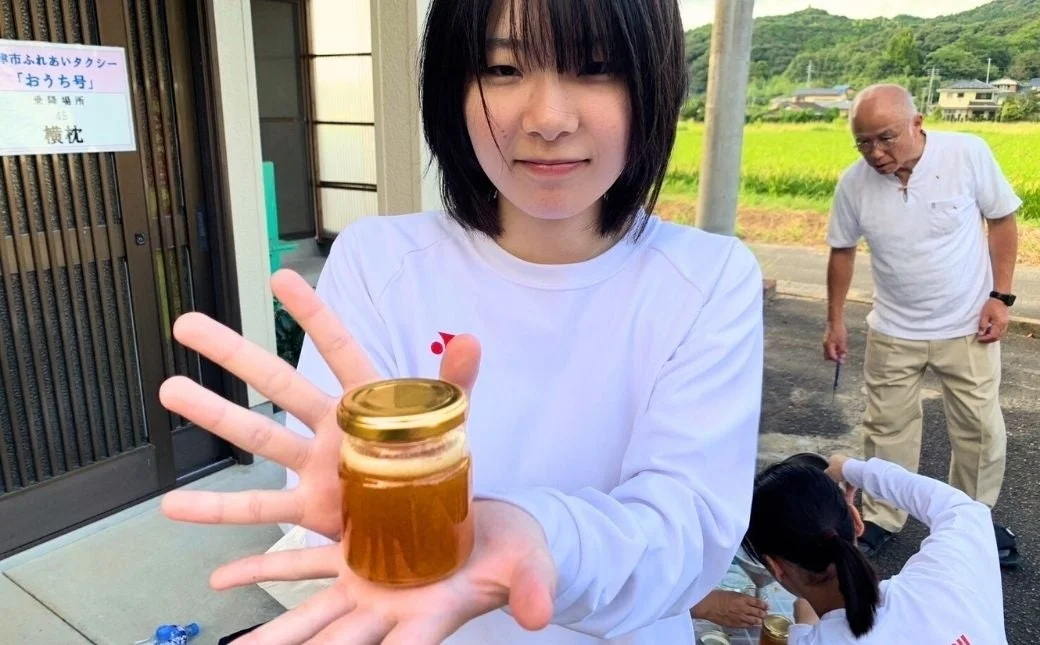 女性が蜂蜜の瓶を持つ様子