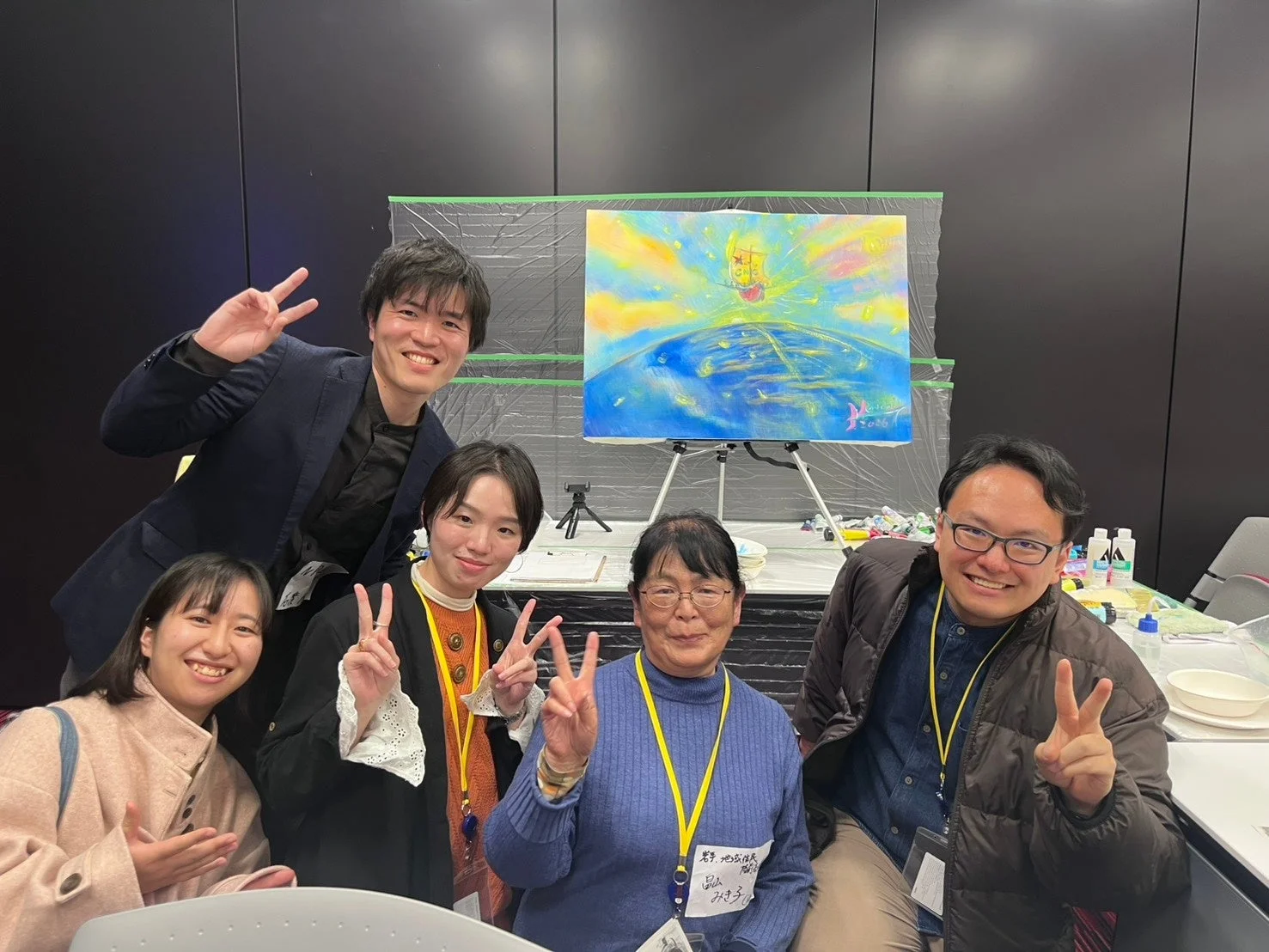 笑顔でピースサインをする5人のグループ写真