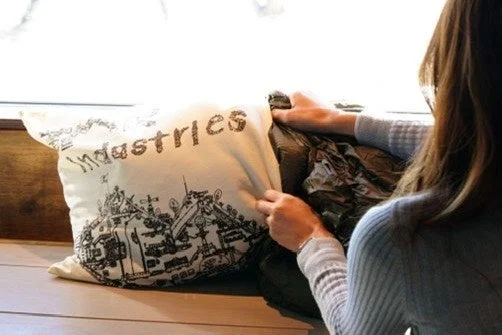 窓辺でクッションを触る女性