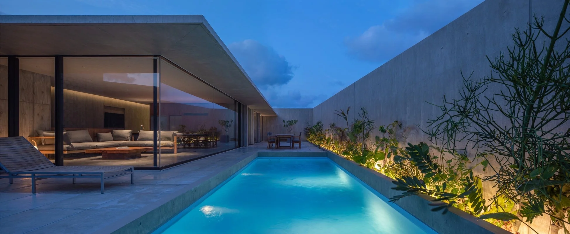 夕暮れ時、または夜のモダンな住宅とプライベートプール