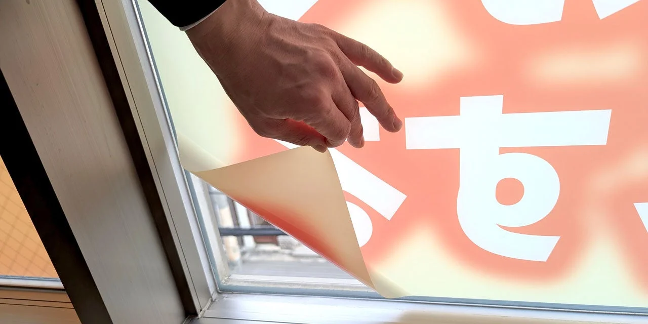 窓からメディアを剥がす様子